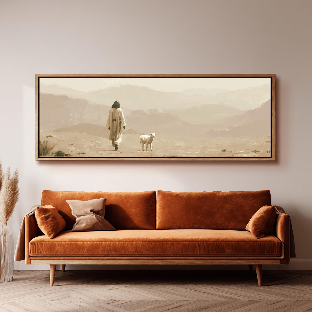 Jesus walking with a lamb through the desert panoramic canvas print above a sofa in a living room