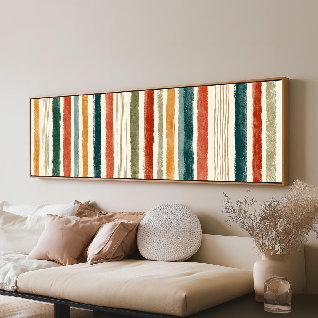 Boho watercolor stripes in mustard, teal and rust long horizontal canvas print above a sofa in a living room