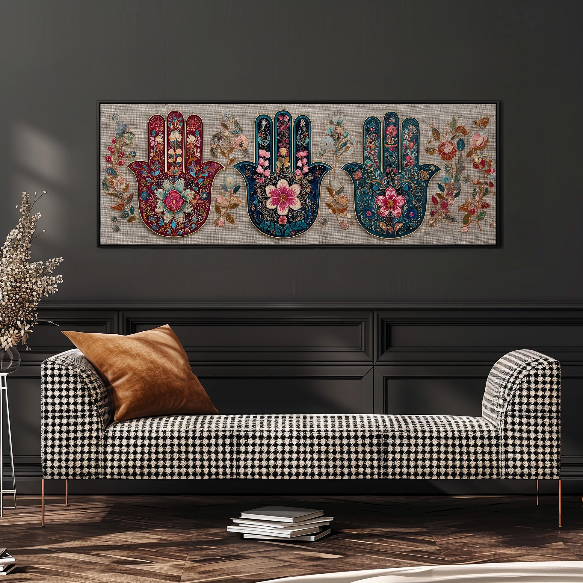 a black and white checkered sofa with a brown throw pillow, set against a gray wall with a large, colorful painting of three hands with floral designs above it.