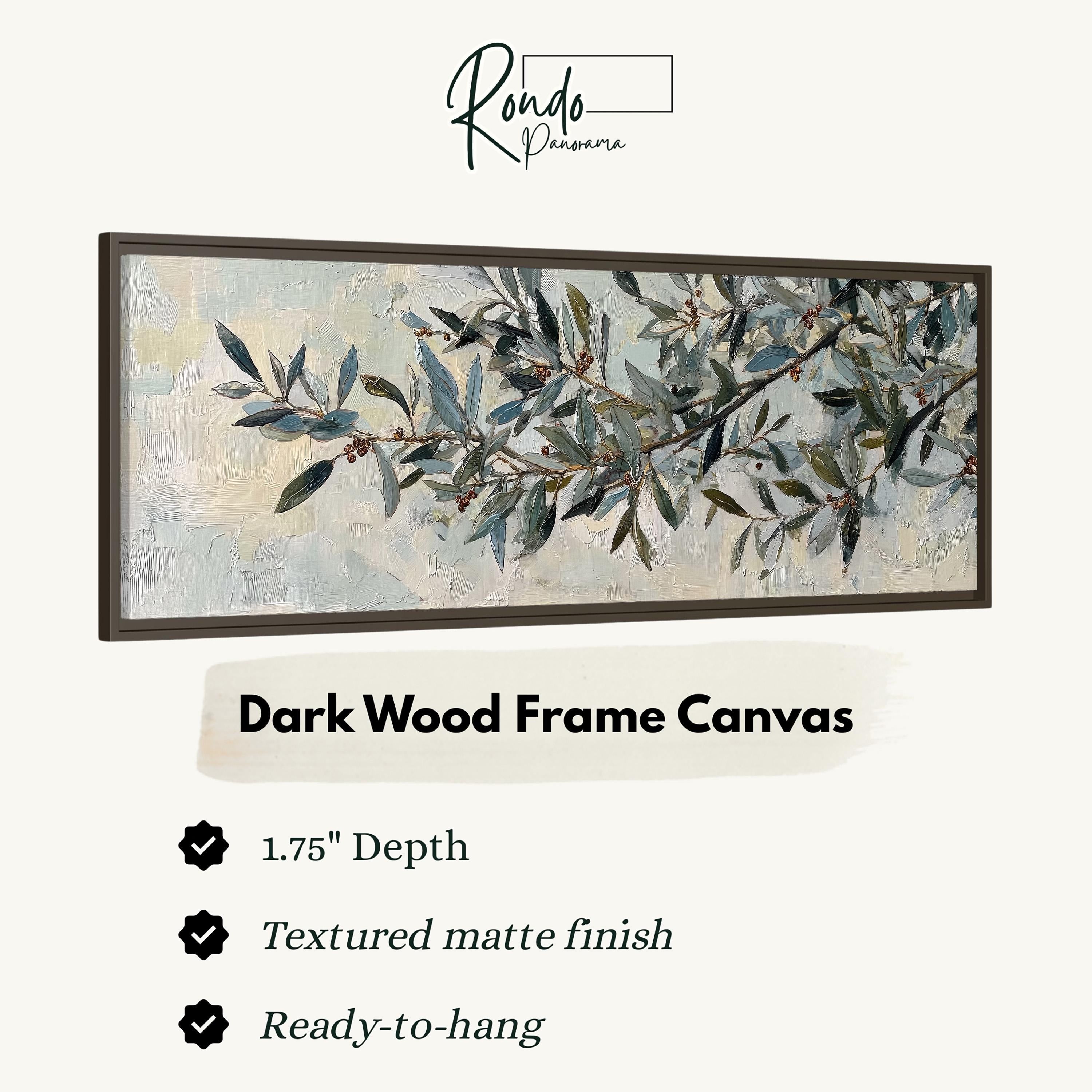The image is a framed artwork depicting a branch with green leaves and small berries. The frame is described as a dark wood frame canvas, with a 1.75" depth and a textured matte finish. It is ready to hang.
