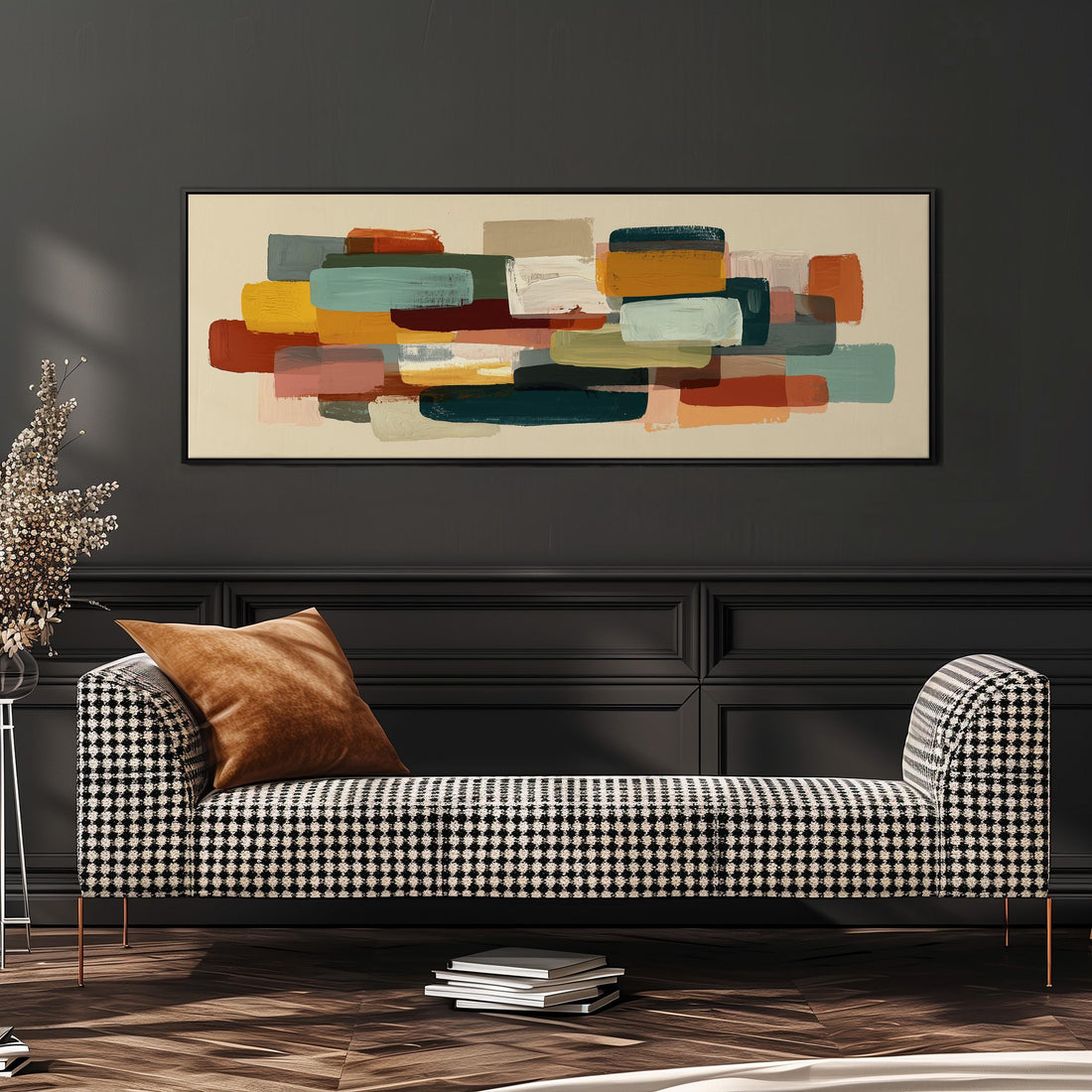 a dining room with a wooden table and four chairs. Above the table, there is a large abstract painting with various colors and shapes. The table is set with a bowl of fruit and a vase of flowers, creating a cozy and inviting atmosphere.