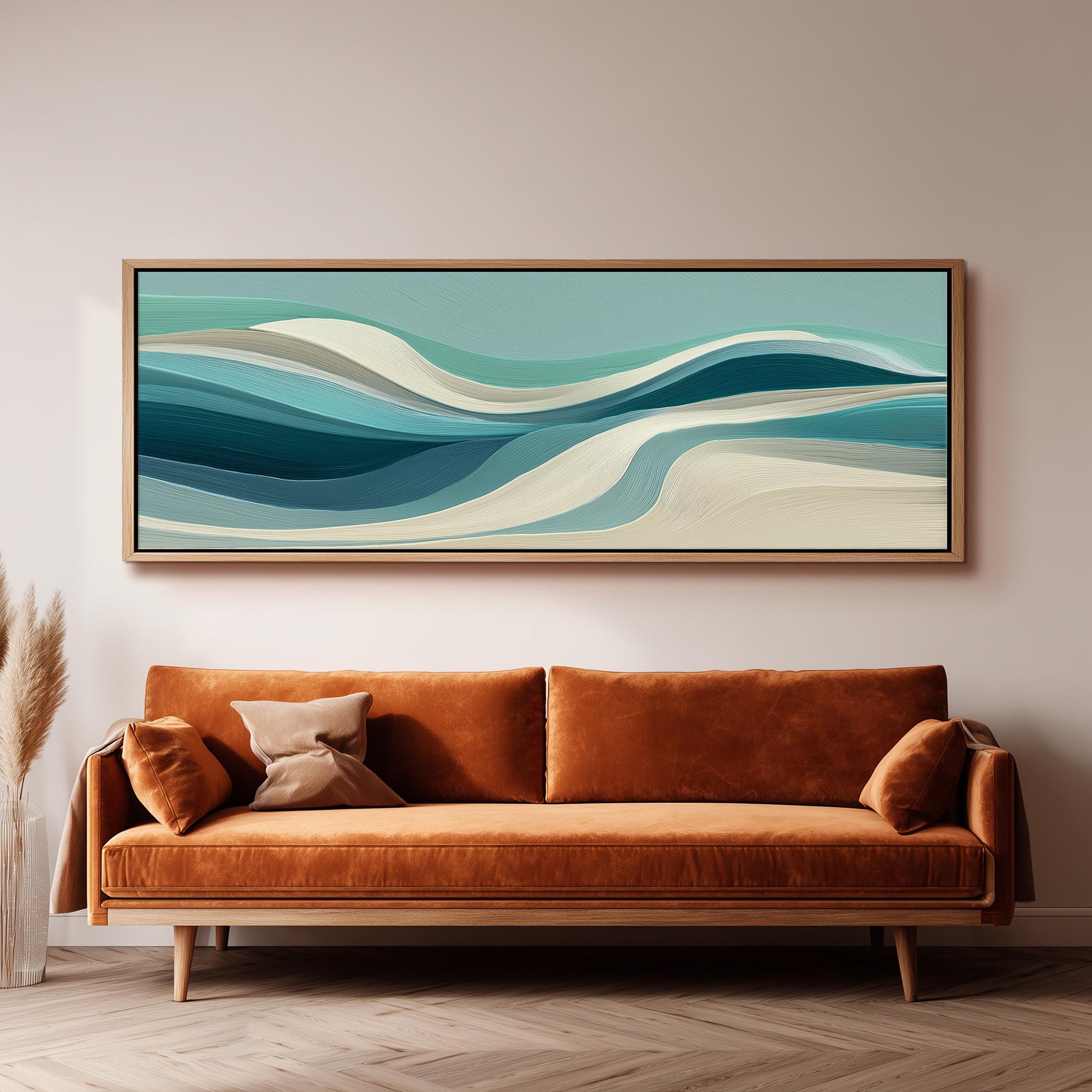 a large abstract painting hanging on a wall above a brown sofa with orange cushions.