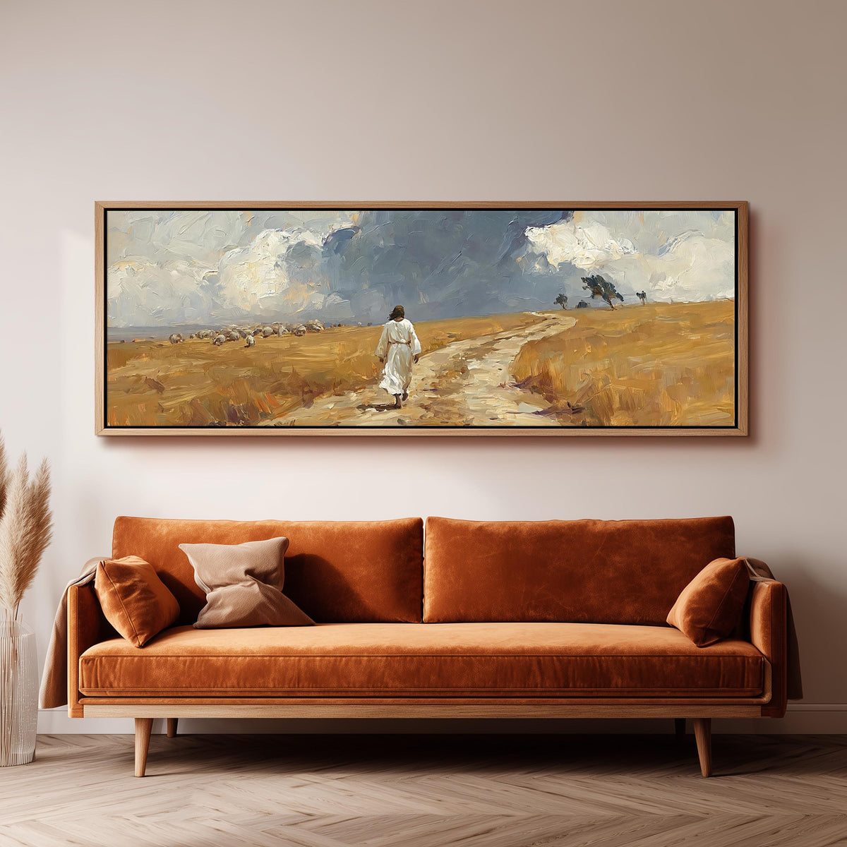 Jesus walking a field path with grazing sheep panoramic canvas print above a sofa in a living room