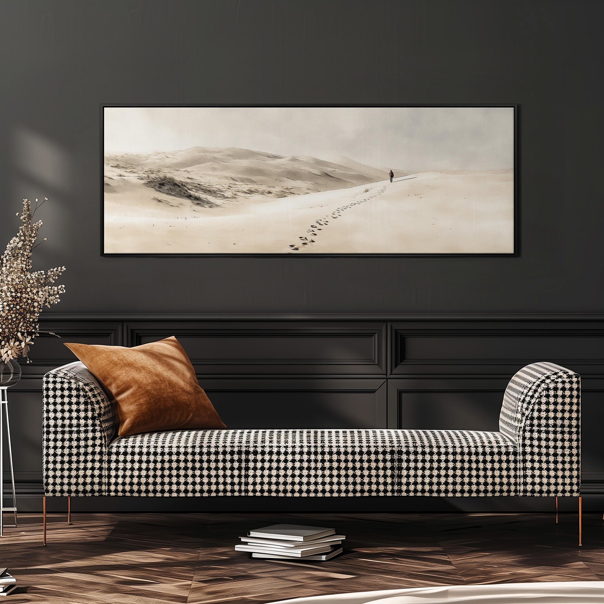 a checkered sofa with a brown throw pillow, set against a dark wall with a framed landscape painting hanging above it.