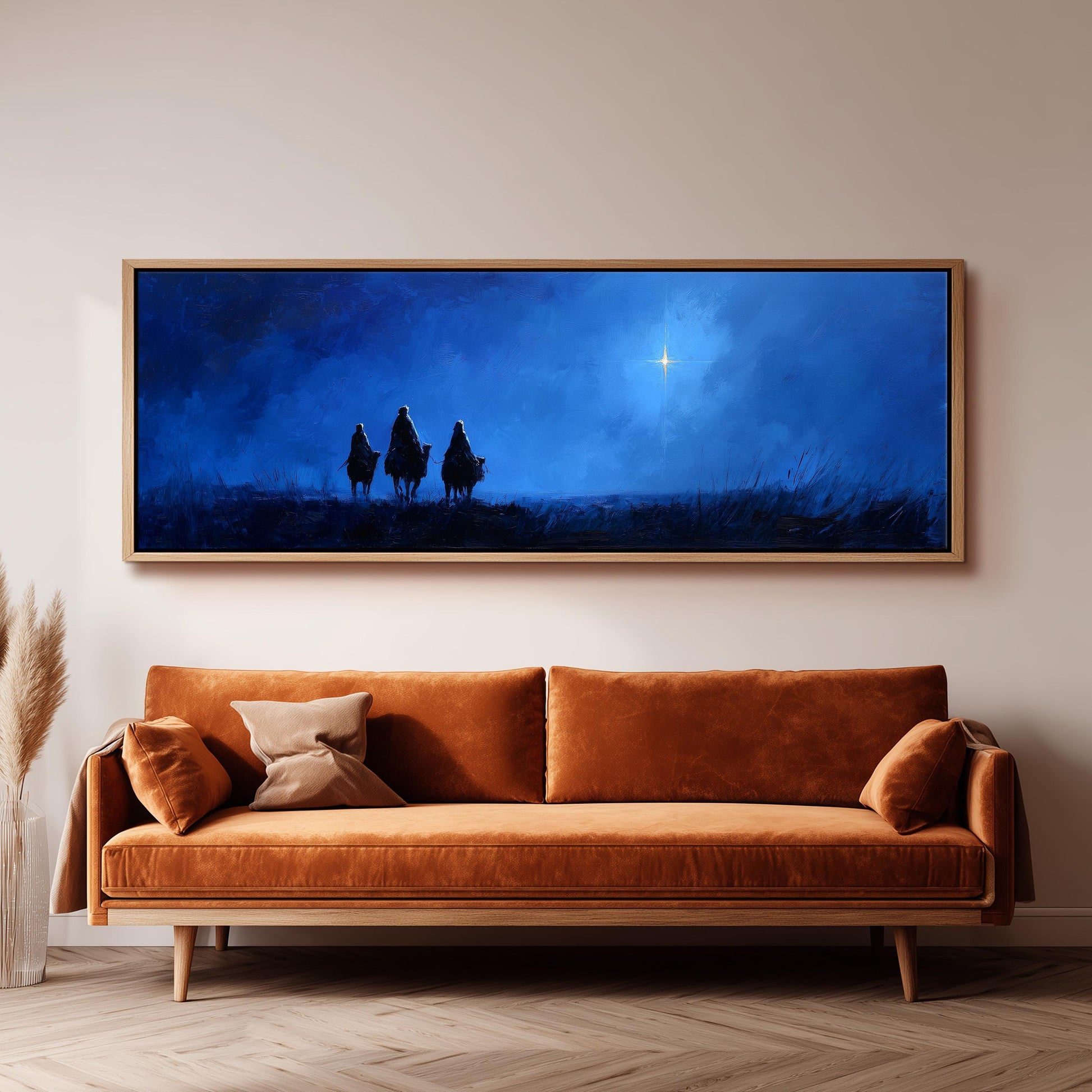 a large, framed painting of three people on horseback against a night sky backdrop, with a bright star visible in the sky.