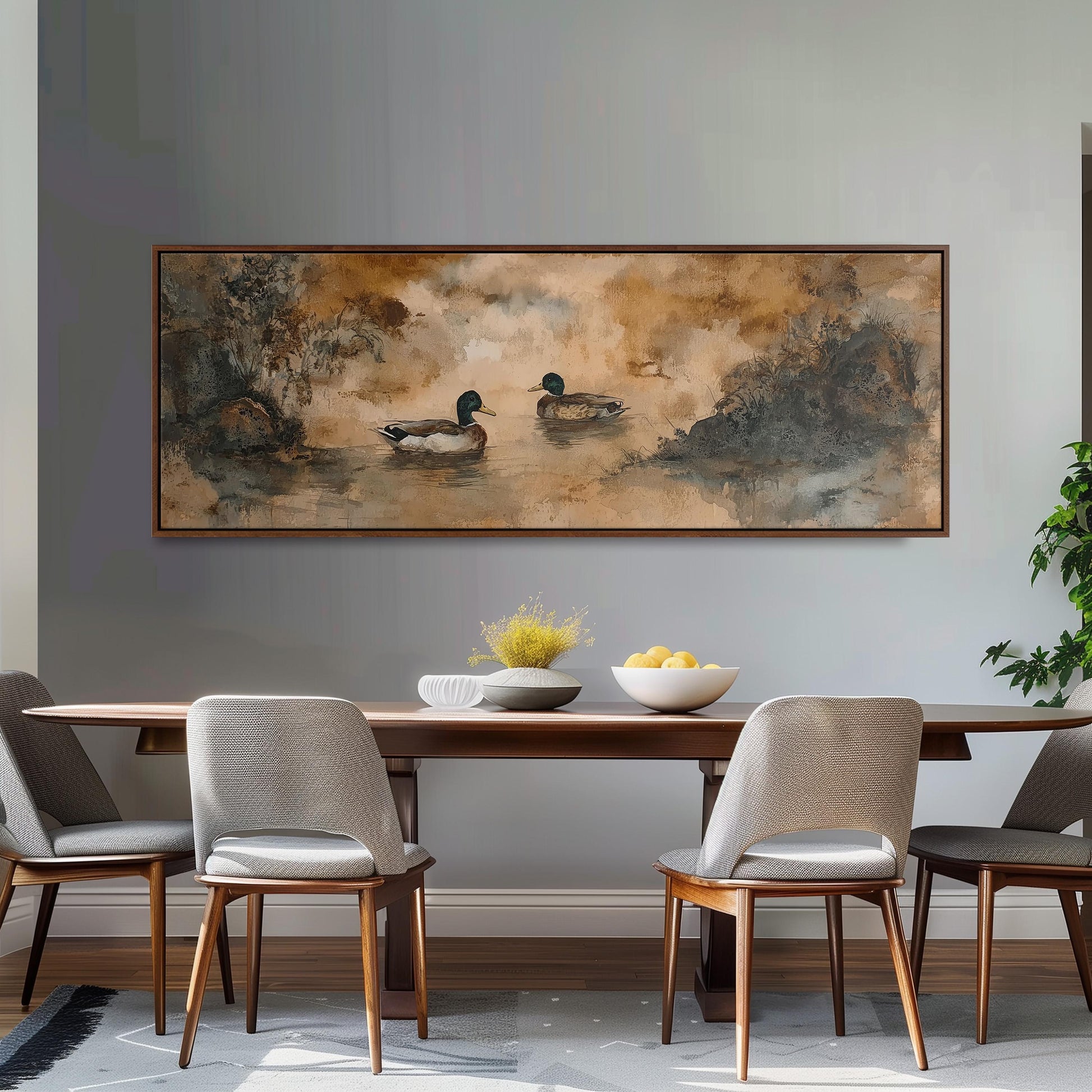 a dining room with a large painting of ducks on the wall above a wooden table with four chairs. The table is set with a bowl of fruit and a vase of flowers.