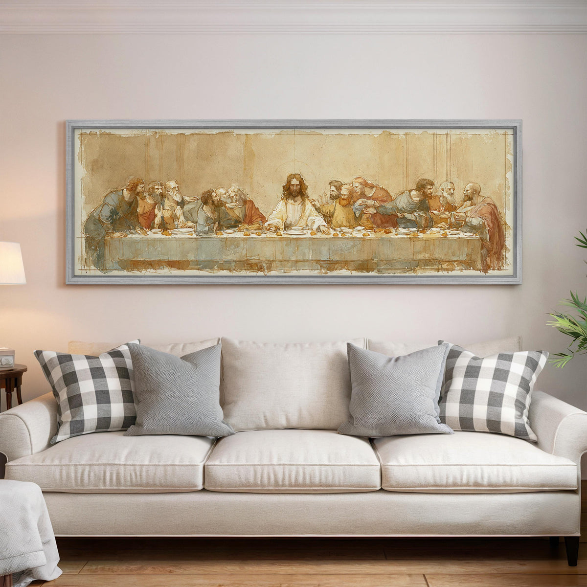 The Last Supper in a sepia sketch style panoramic canvas print above a white sofa in a bright living room
