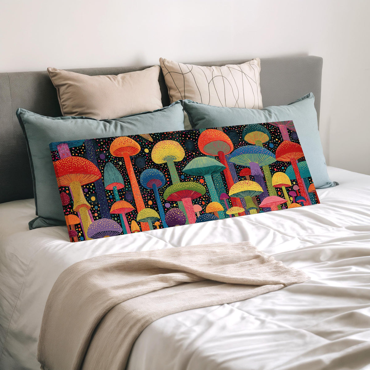 Colorful dotted mushrooms at midnight wide panoramic canvas print laid on a bed to show its size