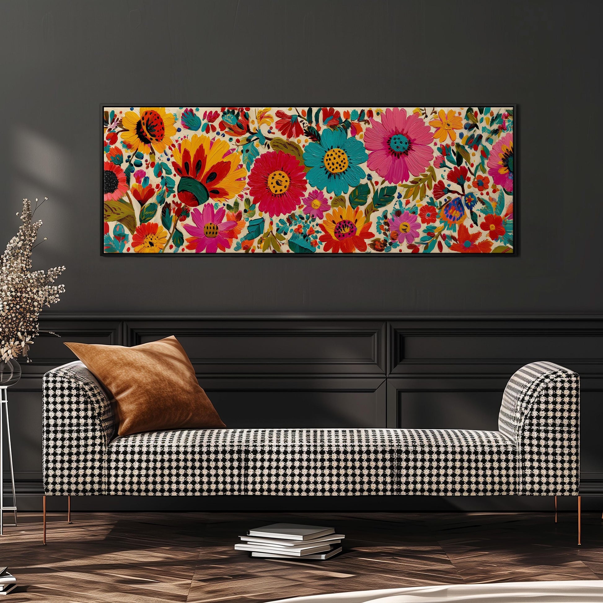 a large, colorful floral print hanging on a wall above a black and white checkered sofa.