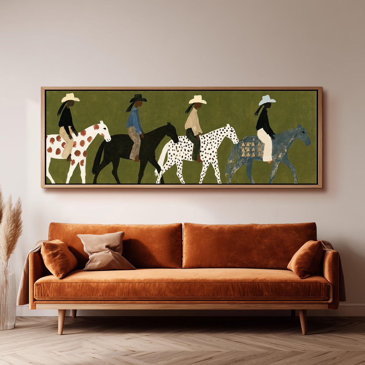Riders on spotted ponies on olive green wide panoramic canvas print above a bench in a dark living room
