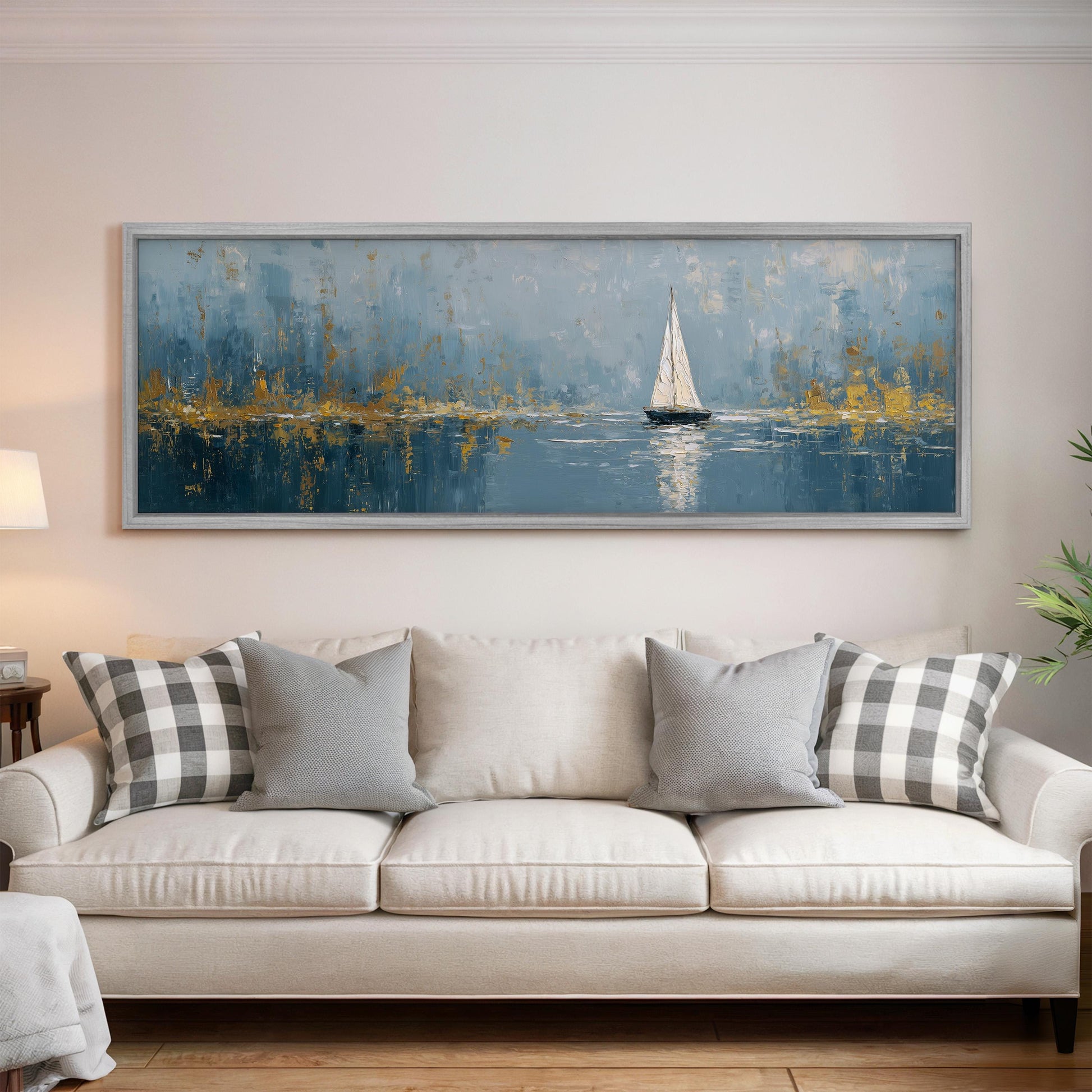 a large painting of a sailboat on a body of water, hanging on a wall above a white sofa with gray and white patterned pillows.