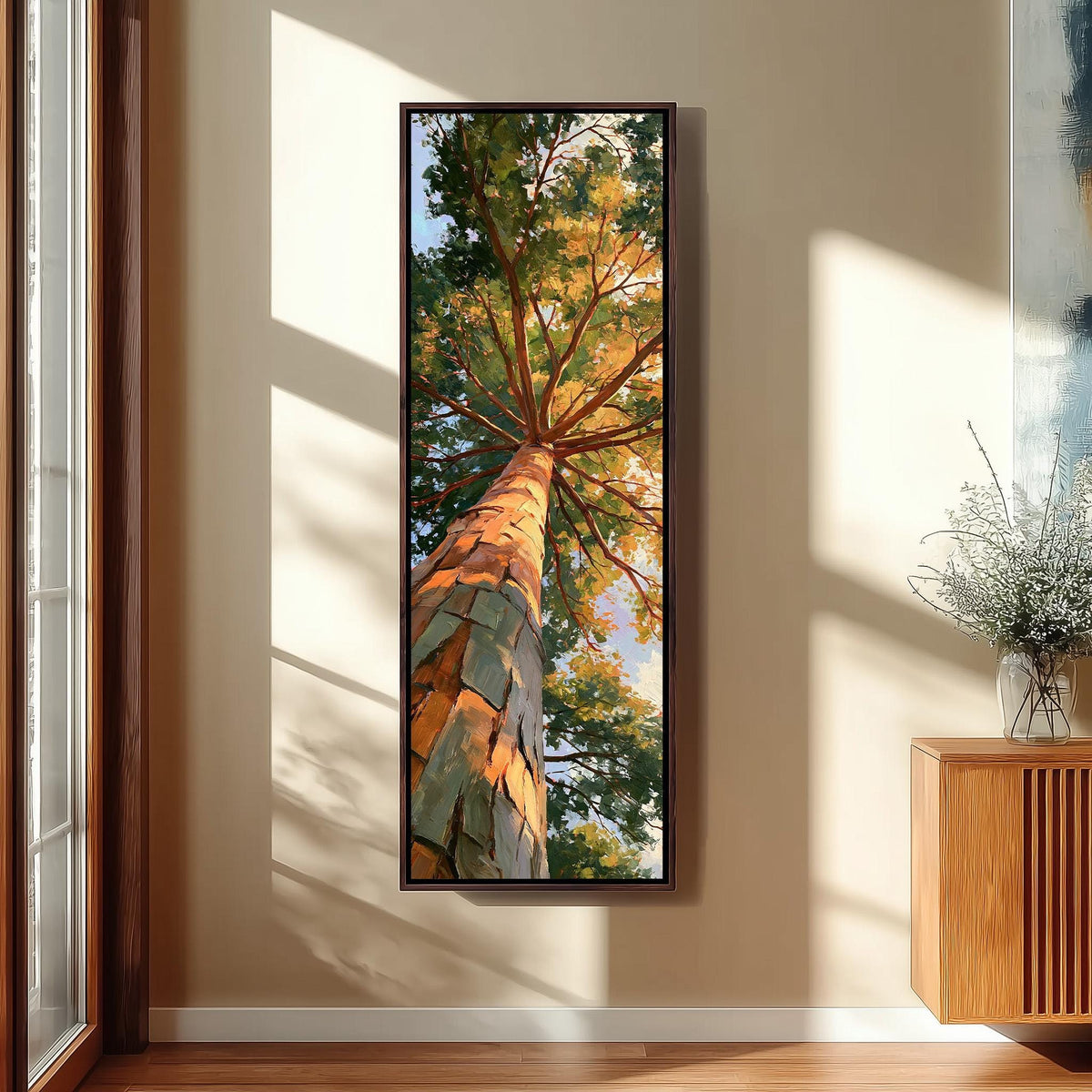 Sunlit pine trunk rising into a green and gold canopy long vertical canvas print in a sunlit living space