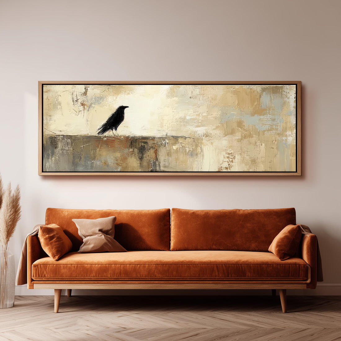 a large, framed painting of a black bird perched on a wall above a brown sofa with orange cushions.