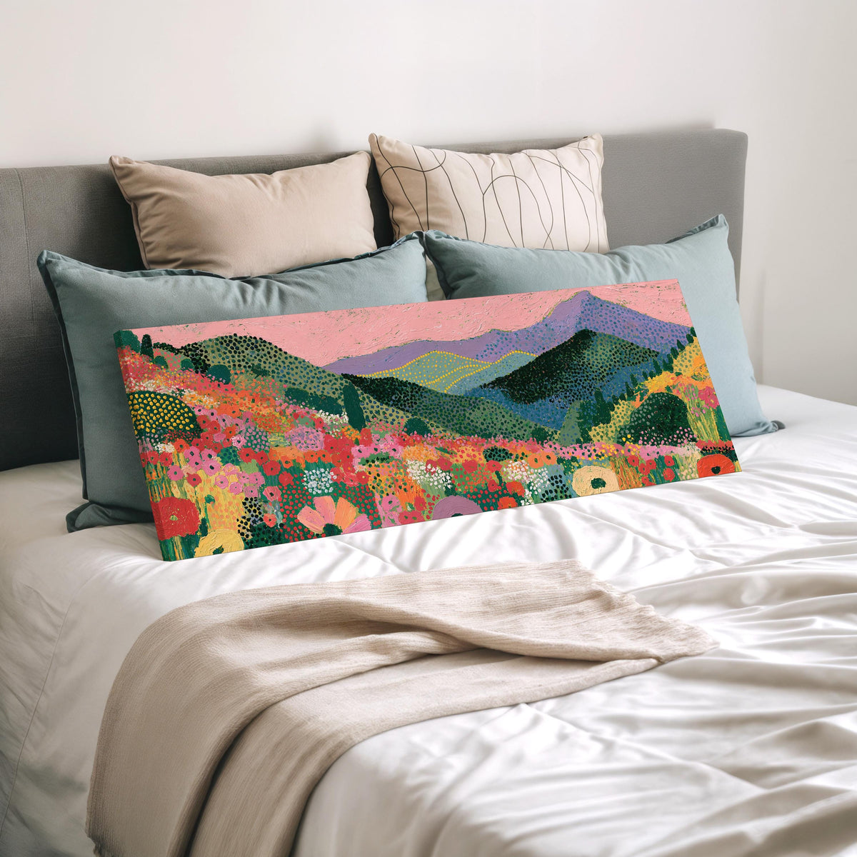 Purple mountains over a flower meadow wide panoramic canvas print laid on a bed to show its size