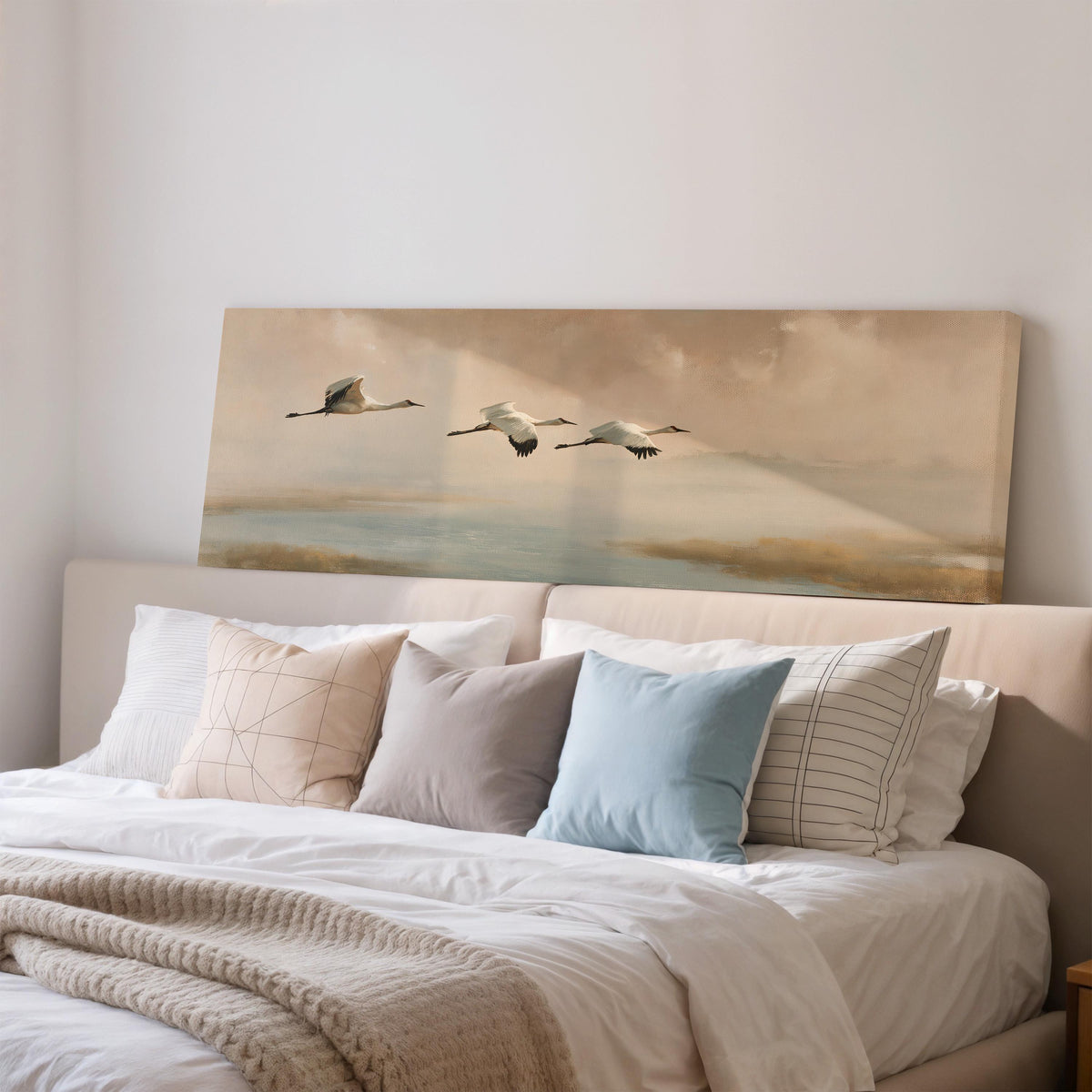 Cranes flying over a calm shore at dusk wide panoramic canvas print above a bed in a bedroom