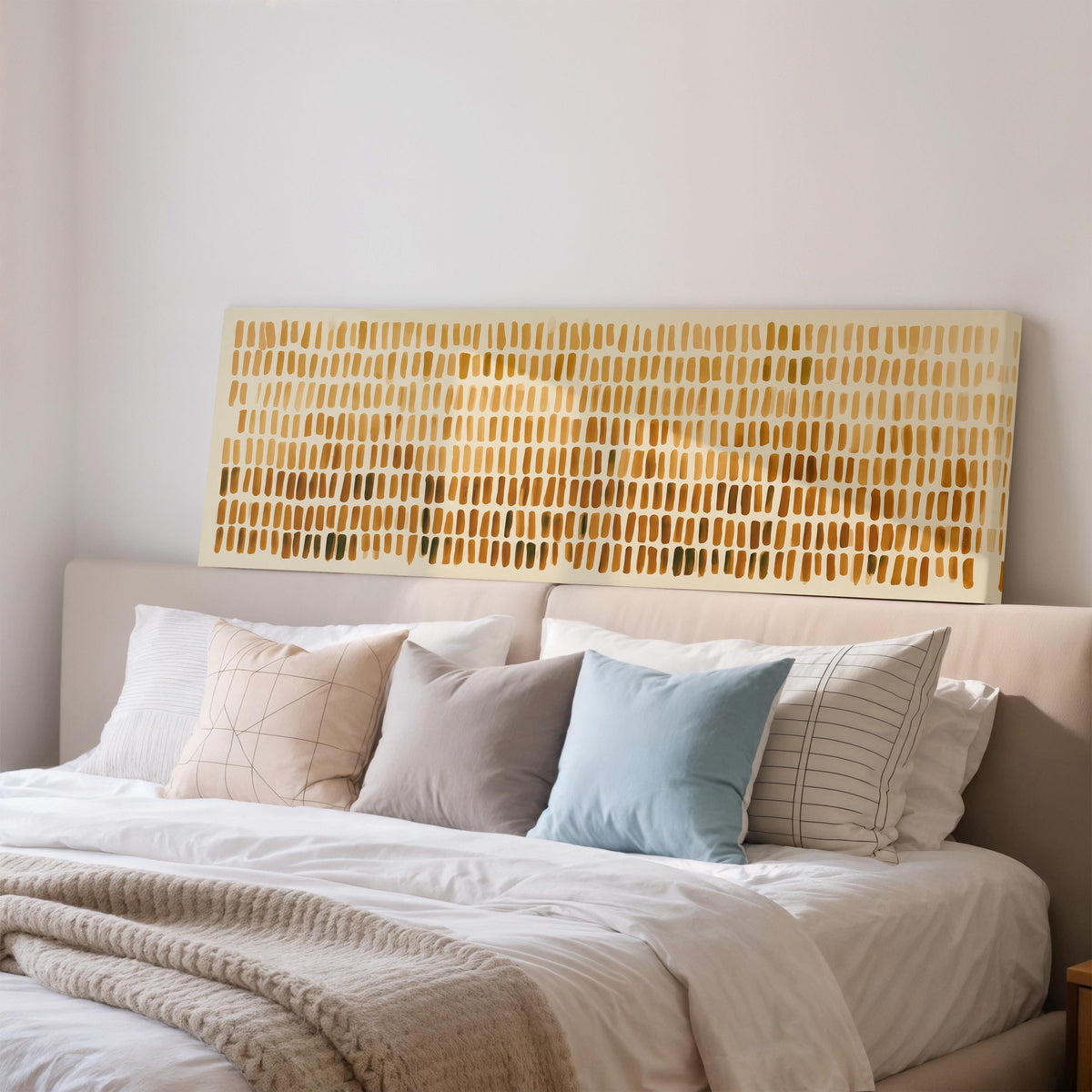 Brushmarks fading from cream to amber wide panoramic canvas print above a bed in a bedroom